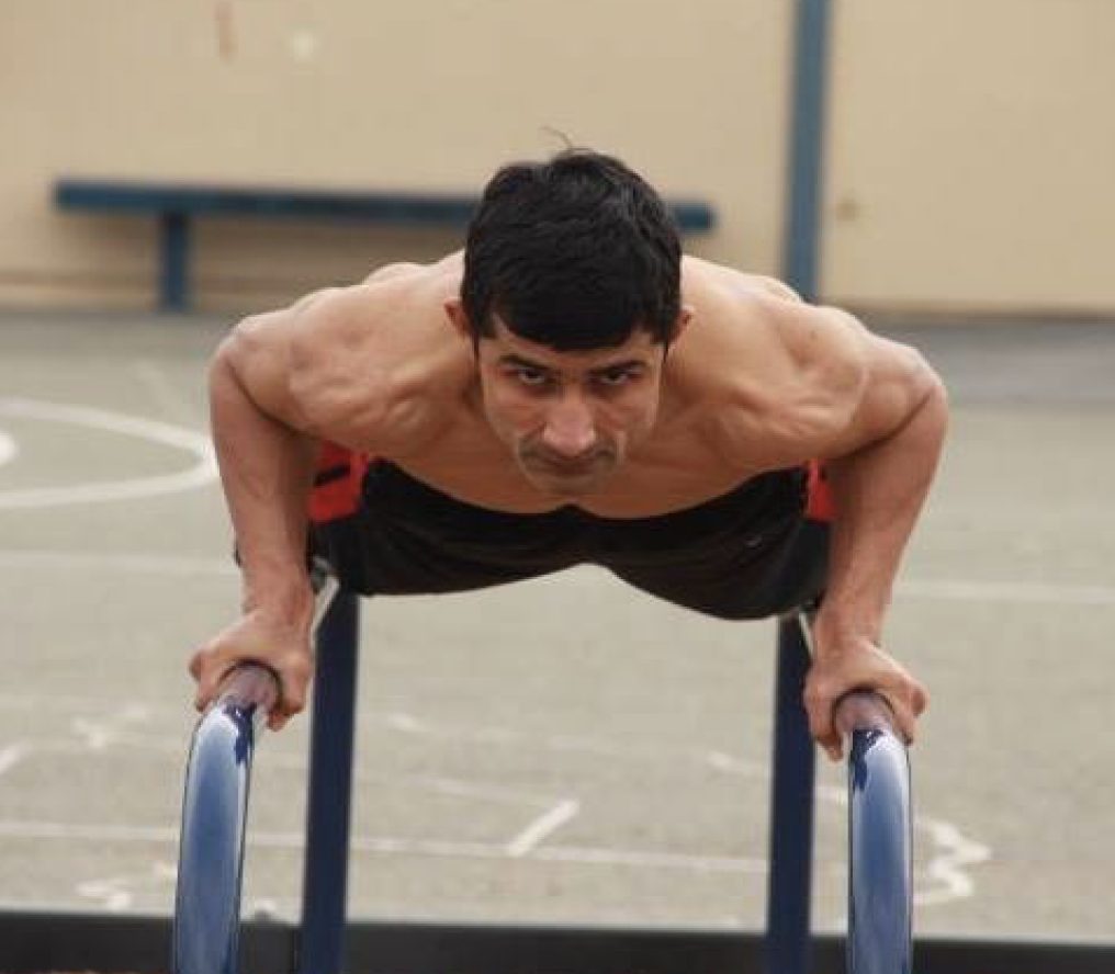 Coach Manjeet doing push-ups on parallel bars